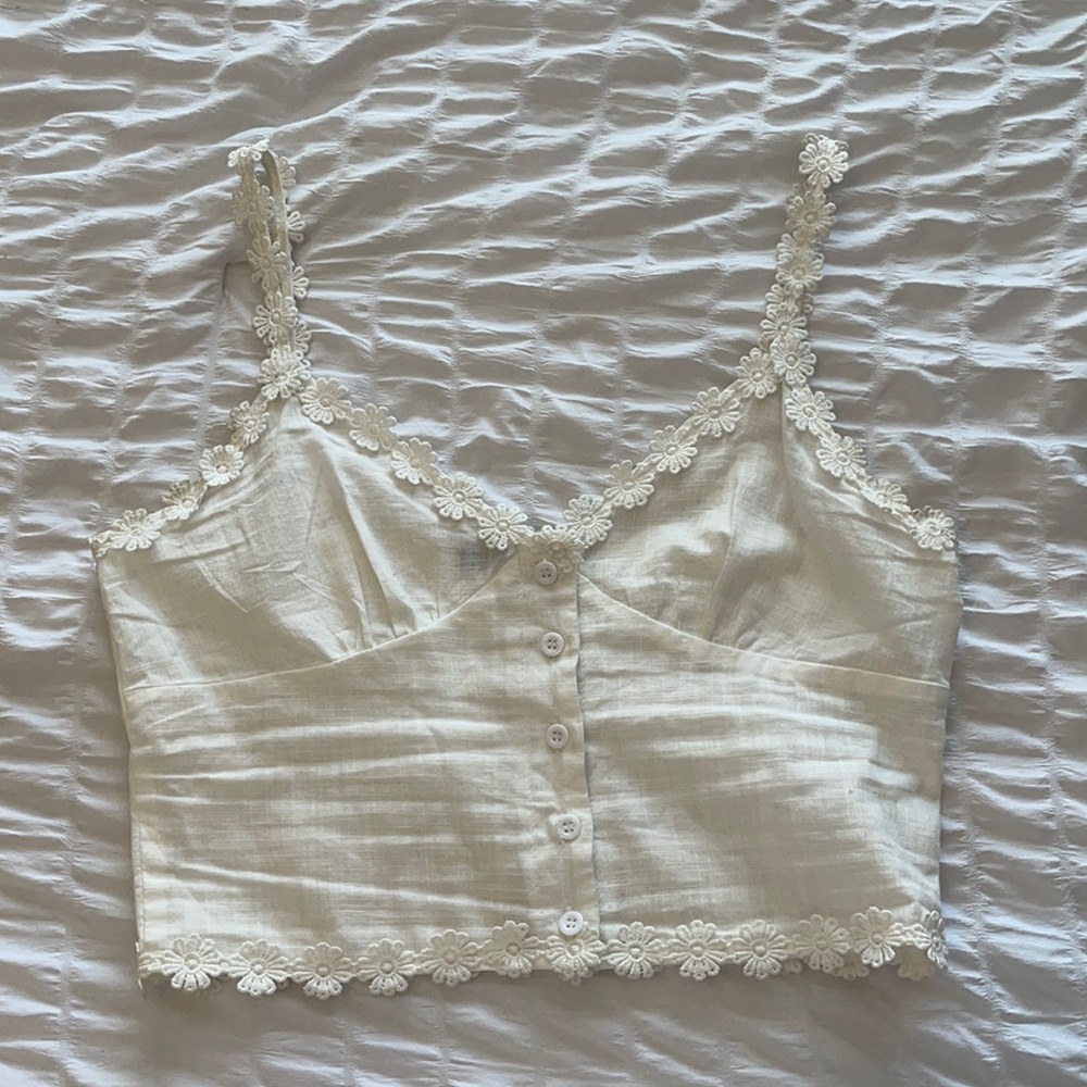 white top with floral trim